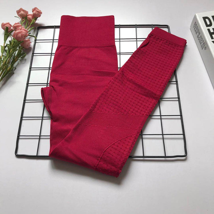Magenta Women's Athletic Set with bra and high-waist pants, featuring textured panels for confident workouts.