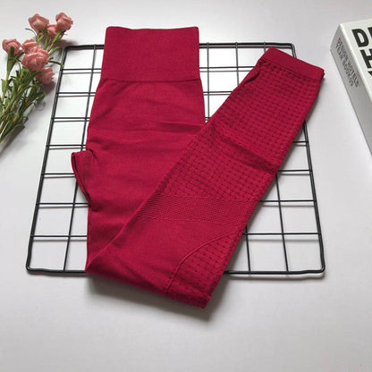 Magenta Women's Athletic Set with bra and high-waist pants, featuring textured panels for confident workouts.
