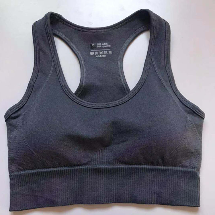 Dark gray women's athletic sports bra with wide straps and ribbed band.